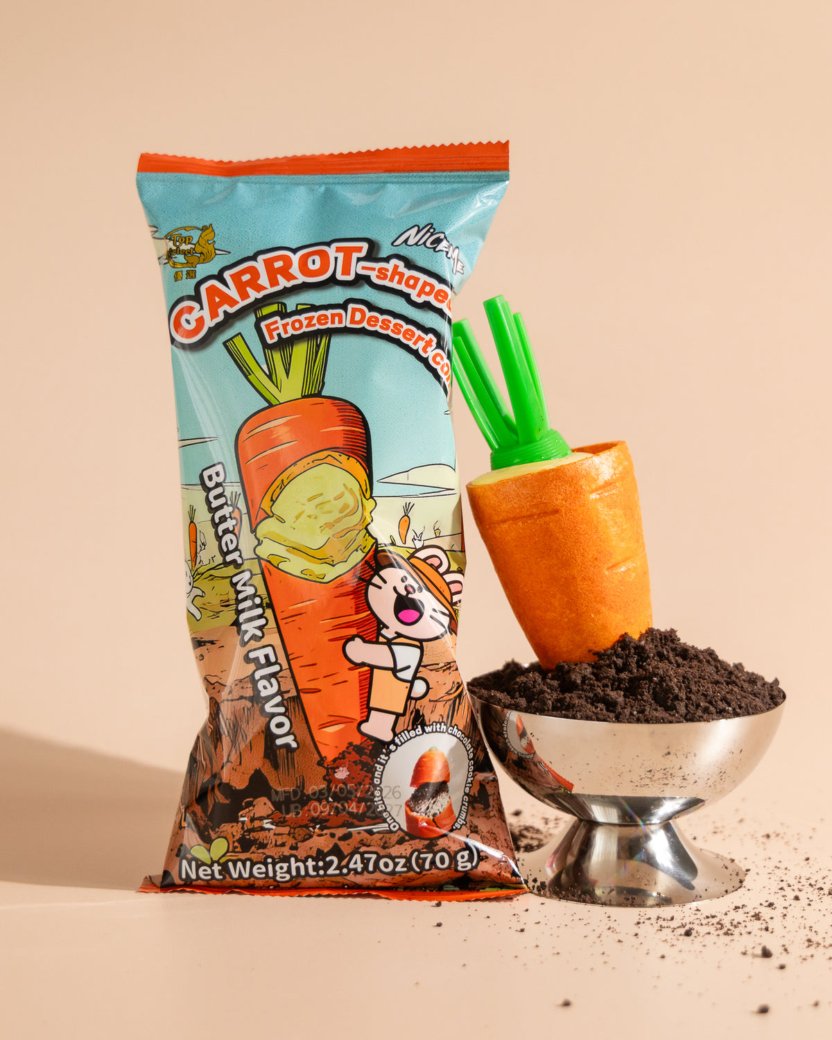 NiceMe Carrot Ice Cream Cone and wrapper beside a bowl of chocolate cookie crumbs.