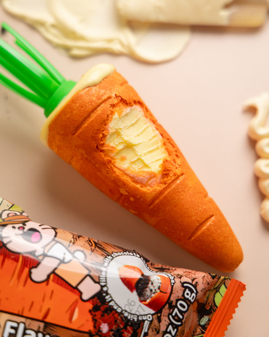Close-up of a NiceMe carrot-shaped wafer cone with its filling exposed beside the wrapper.
