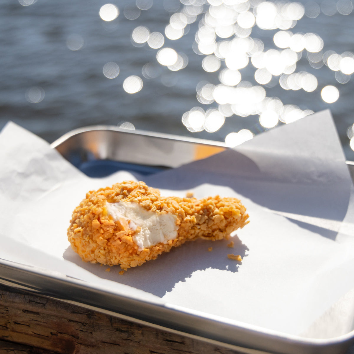 NiceMe fried chicken-shaped ice cream on a tray beside the water — LLB-3074.jpg